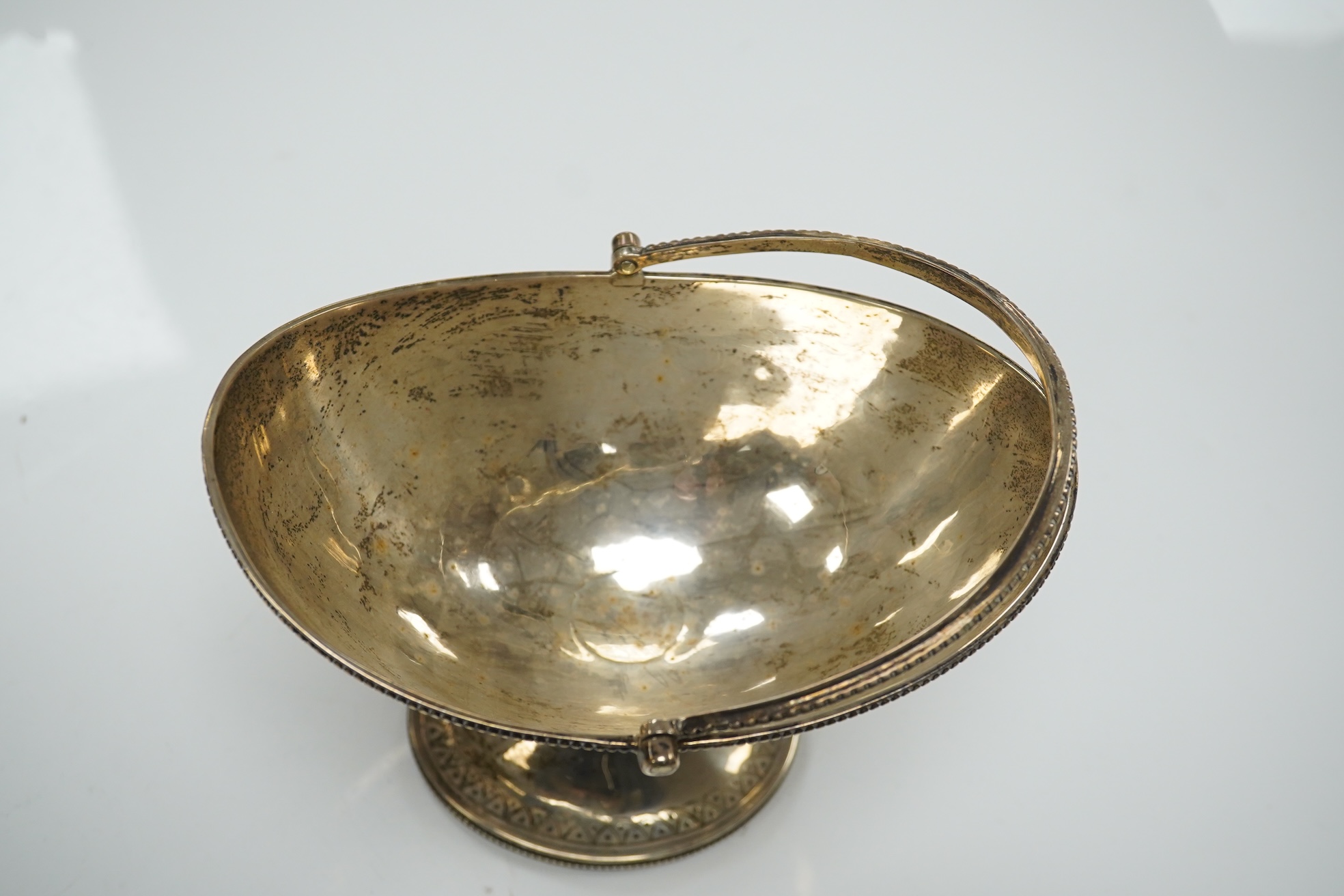 A Victorian engraved silver oval pedestal sugar basket, Henry Holland, London, 1869, width 15.5cm, 7.3oz. Condition - poor